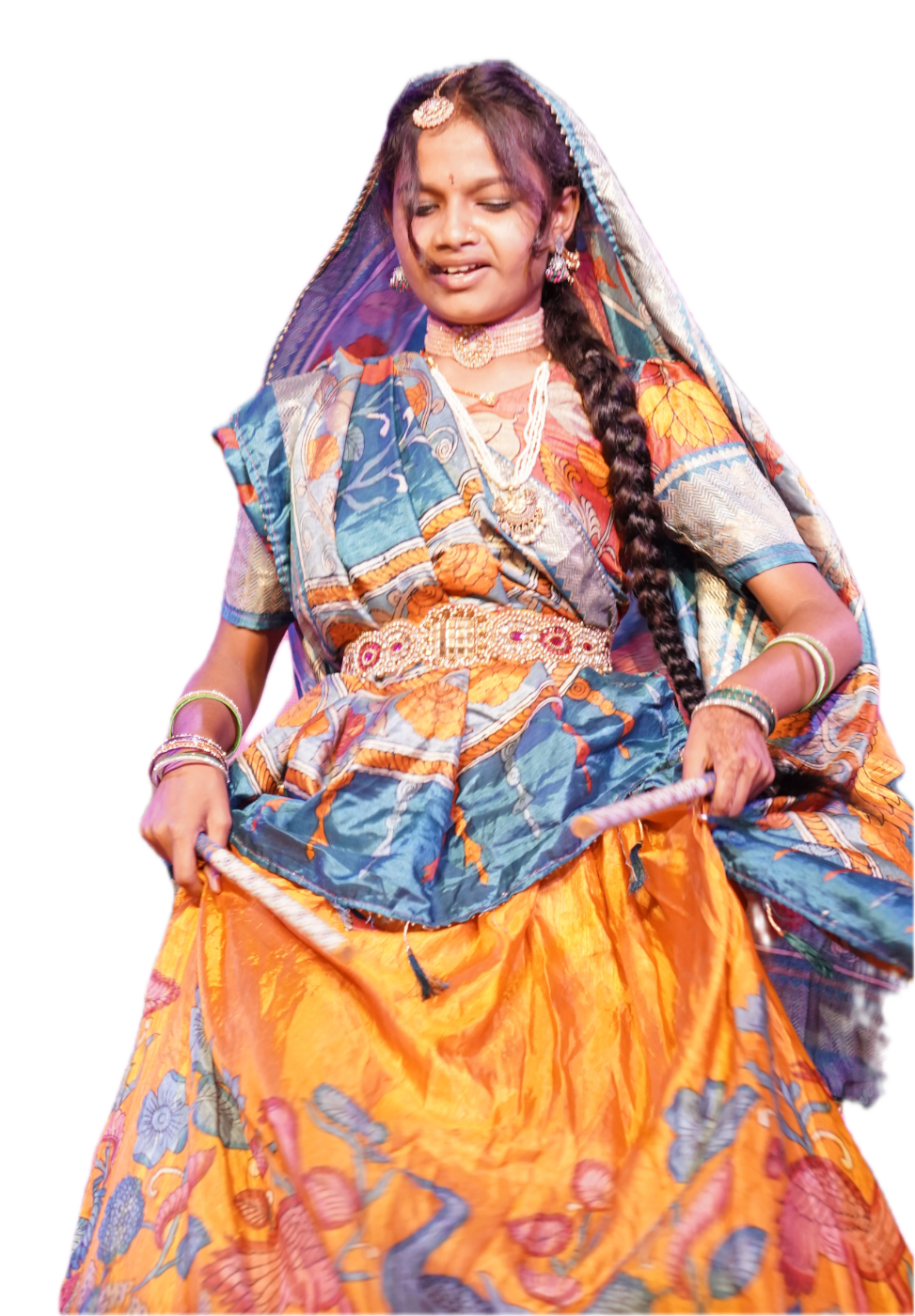A girl in a mirror-work lehenga and dupatta, dancing on stage