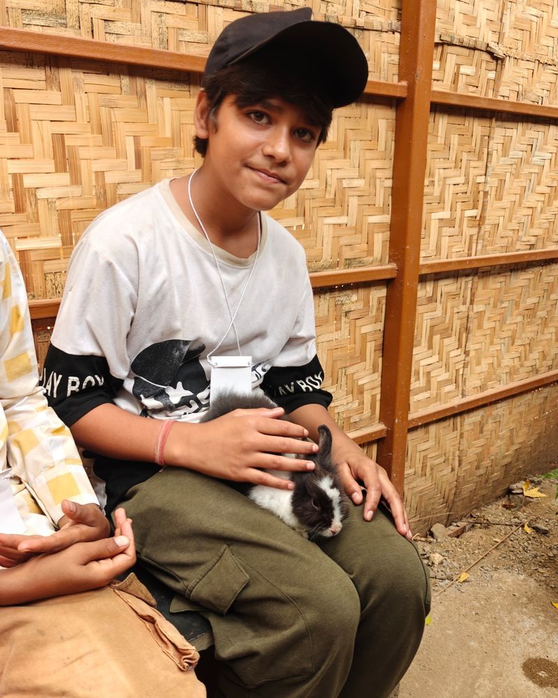 A boy holding a rabbit on the Prani visit